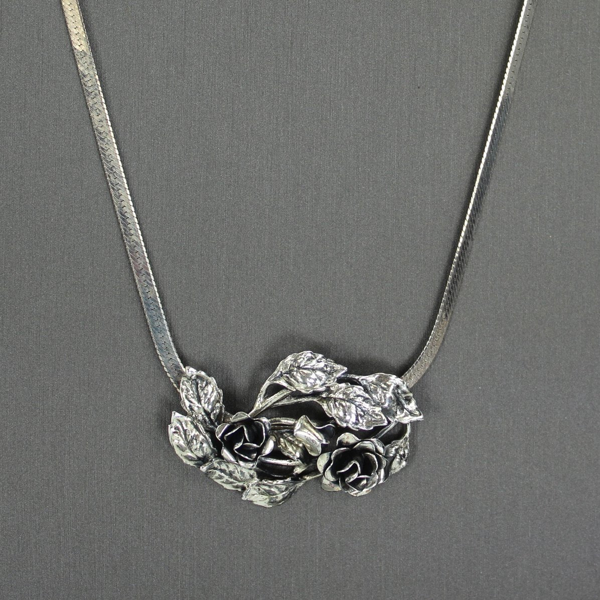 Danecraft Vintage Pendant Necklace 925 Sterling Dimensional Roses Leaves on neck closeup