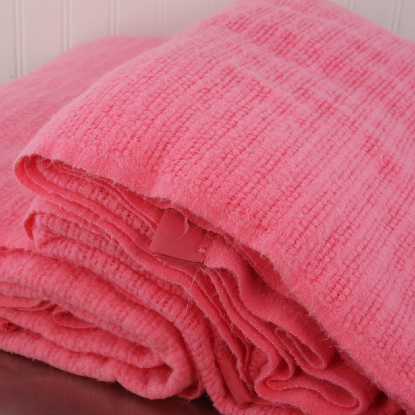pair pink acrylic blankets stacked showing edges