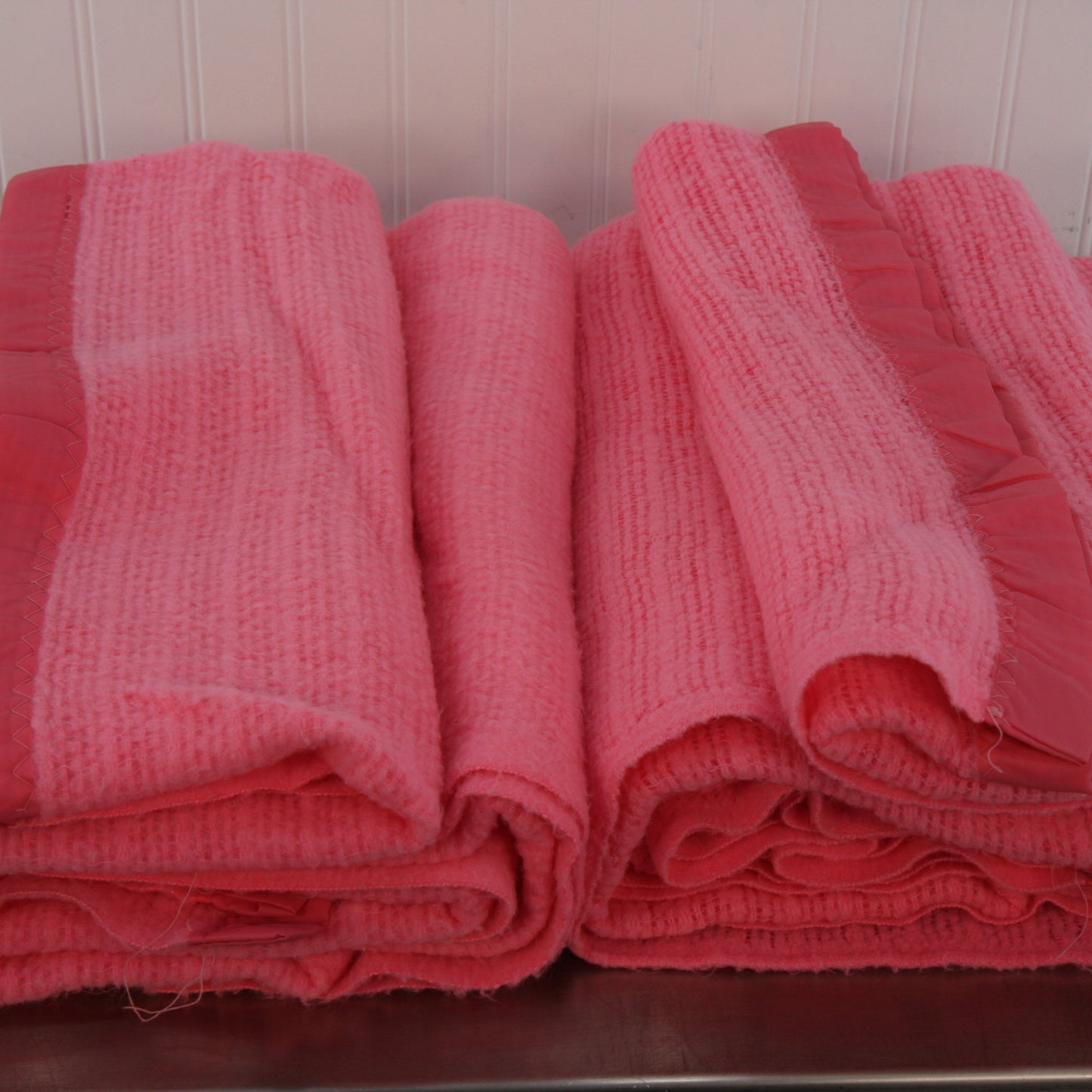 pair pink acrylic blankets stacked showing folded