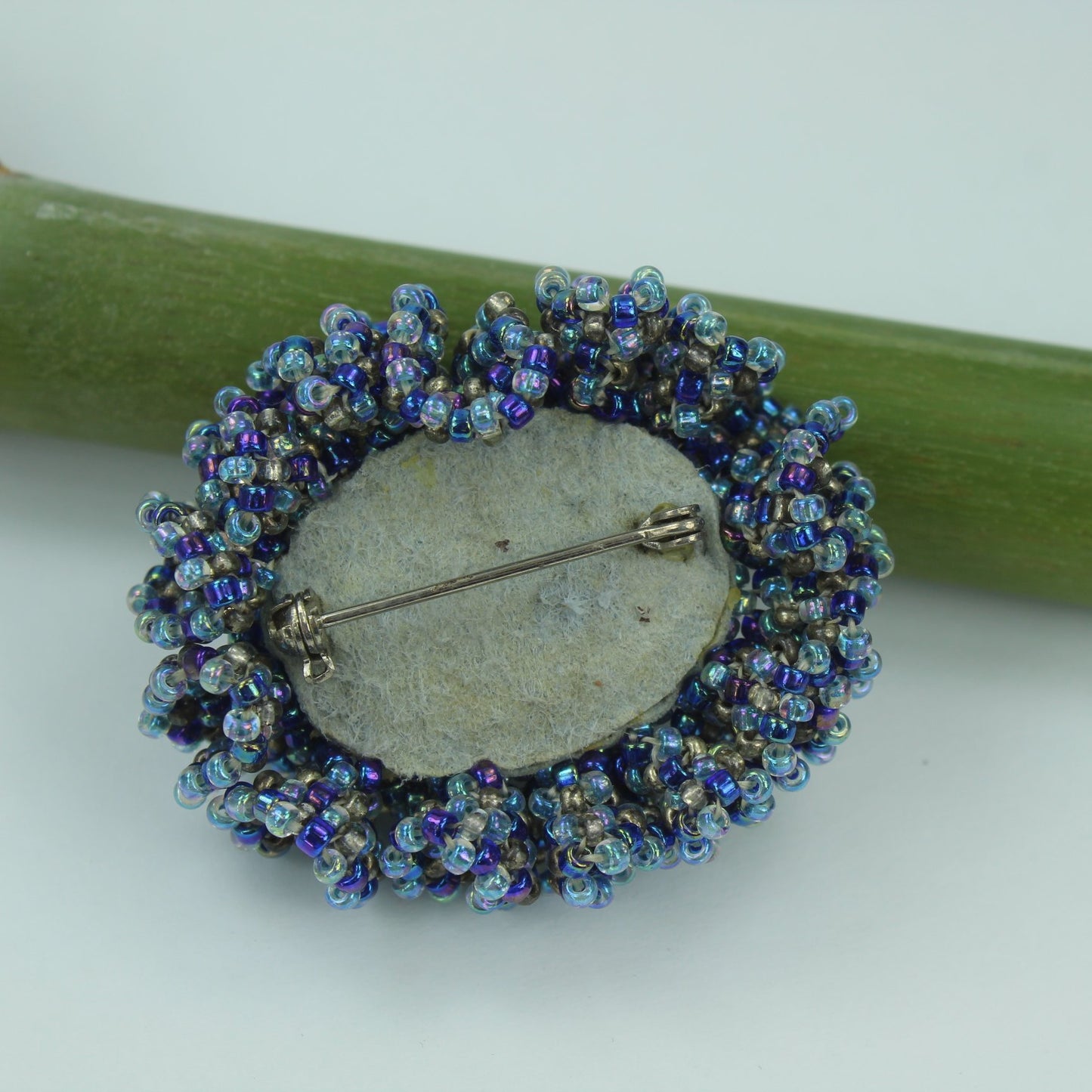 Pat Falk Early Work Glass Pin Iridescent Bead Ruffle Surround Brilliant Blues reverse fabric back