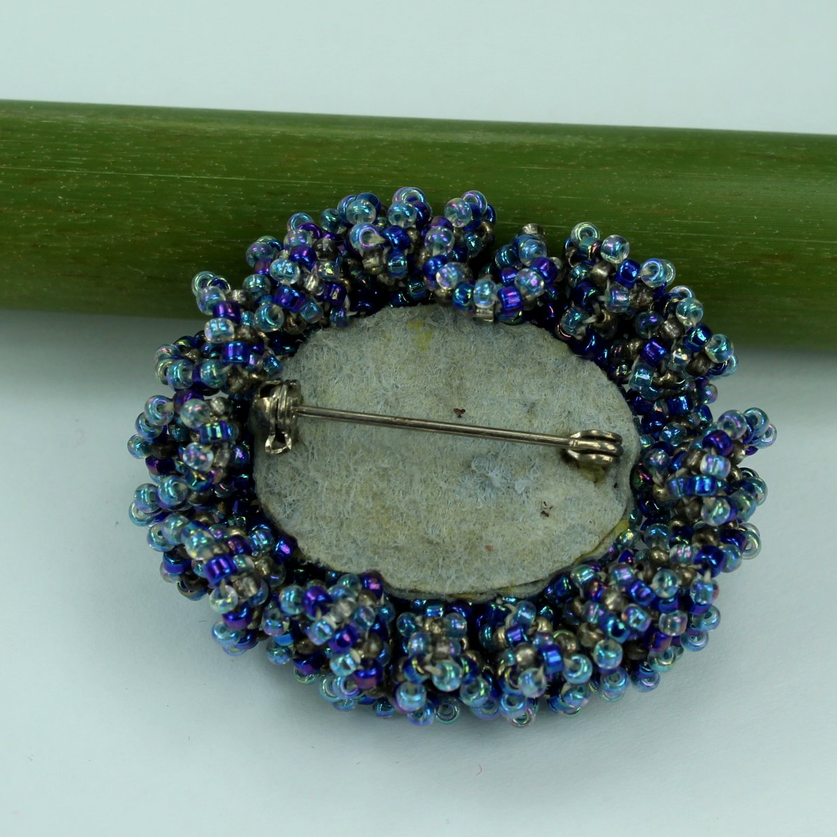 Pat Falk Early Work Glass Pin Iridescent Bead Ruffle Surround Brilliant Blues back of pin with locking closure