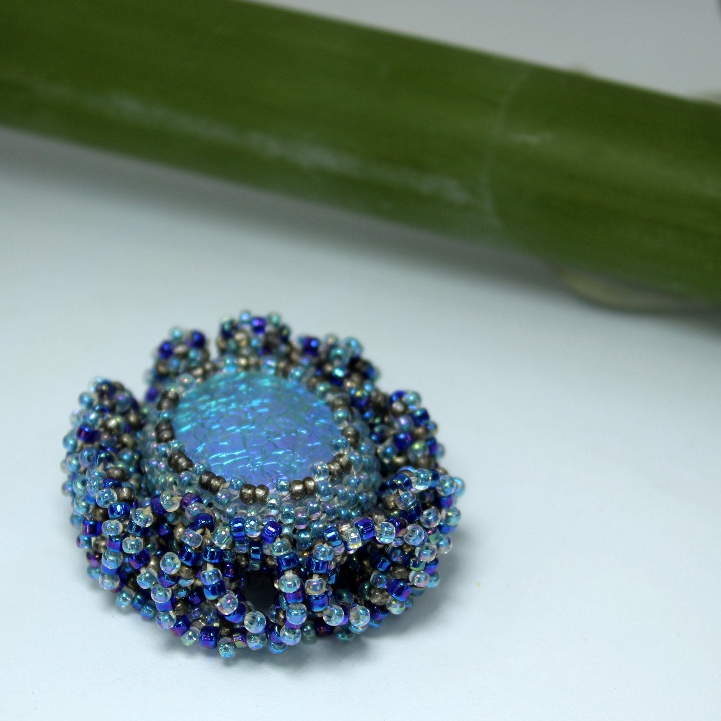 Pat Falk Early Work Glass Pin Iridescent Bead Ruffle Surround Brilliant Blues top cabochon