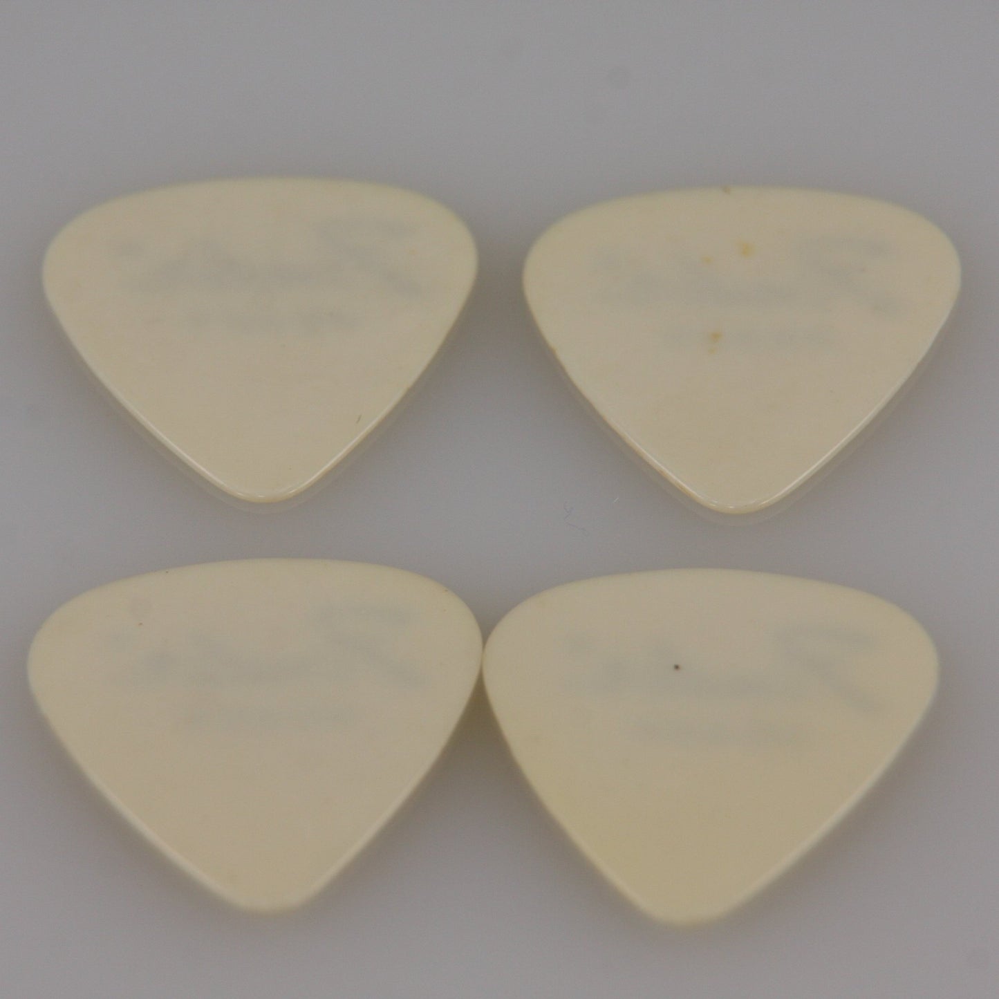 Lot of Four Vintage Guitar Picks White Fender Heavy from Roadie Stash