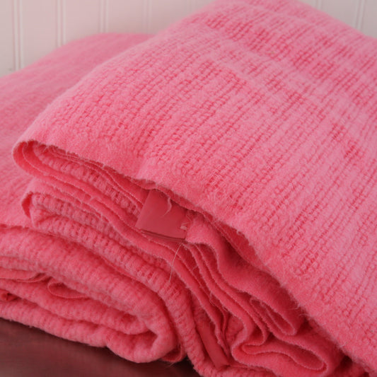 pair pink acrylic blankets stacked showing edges