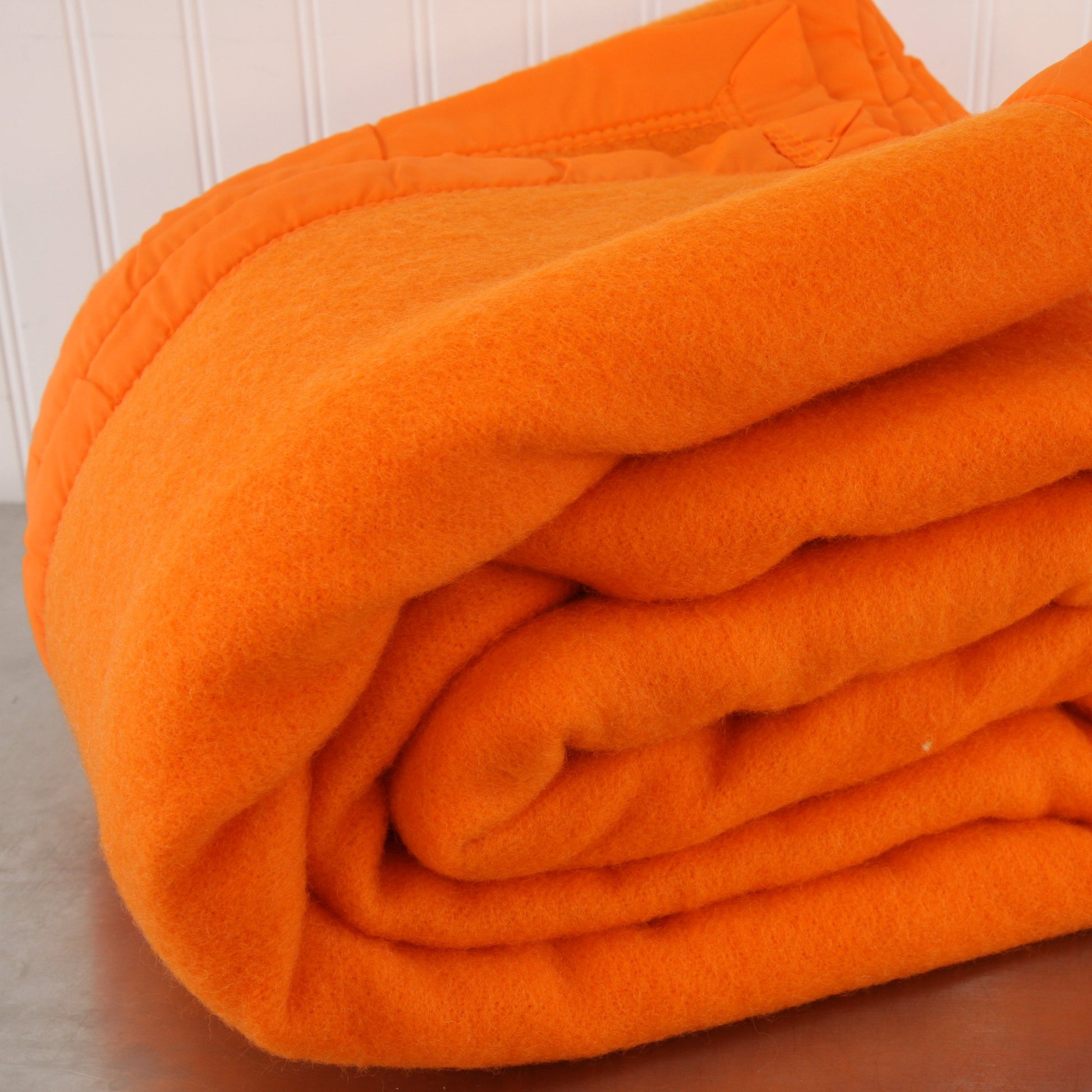 Folded Riviera Manta Acrylic Orange Blanket Front View