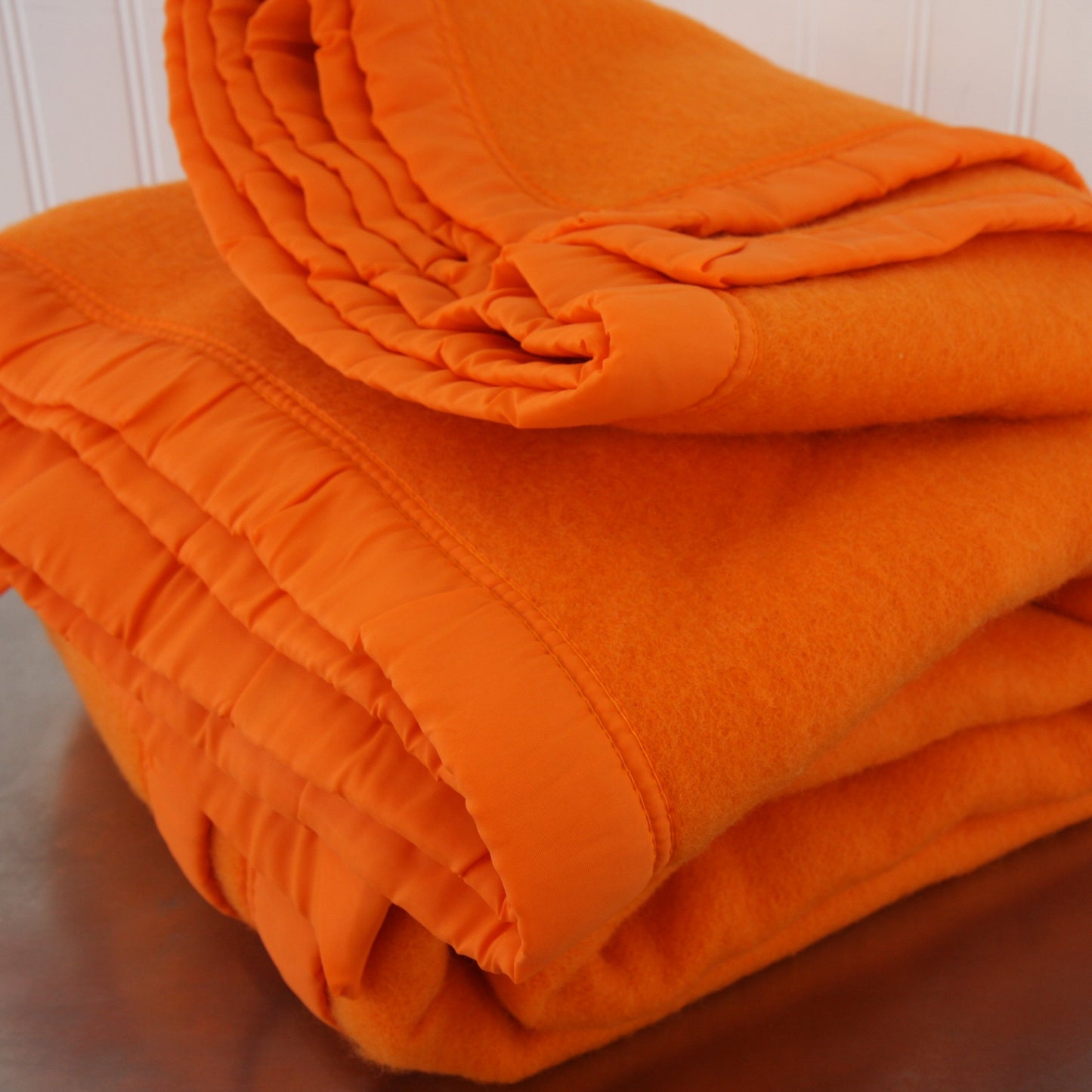 Folded Riviera Manta Acrylic Orange Blanket Front View Bindings