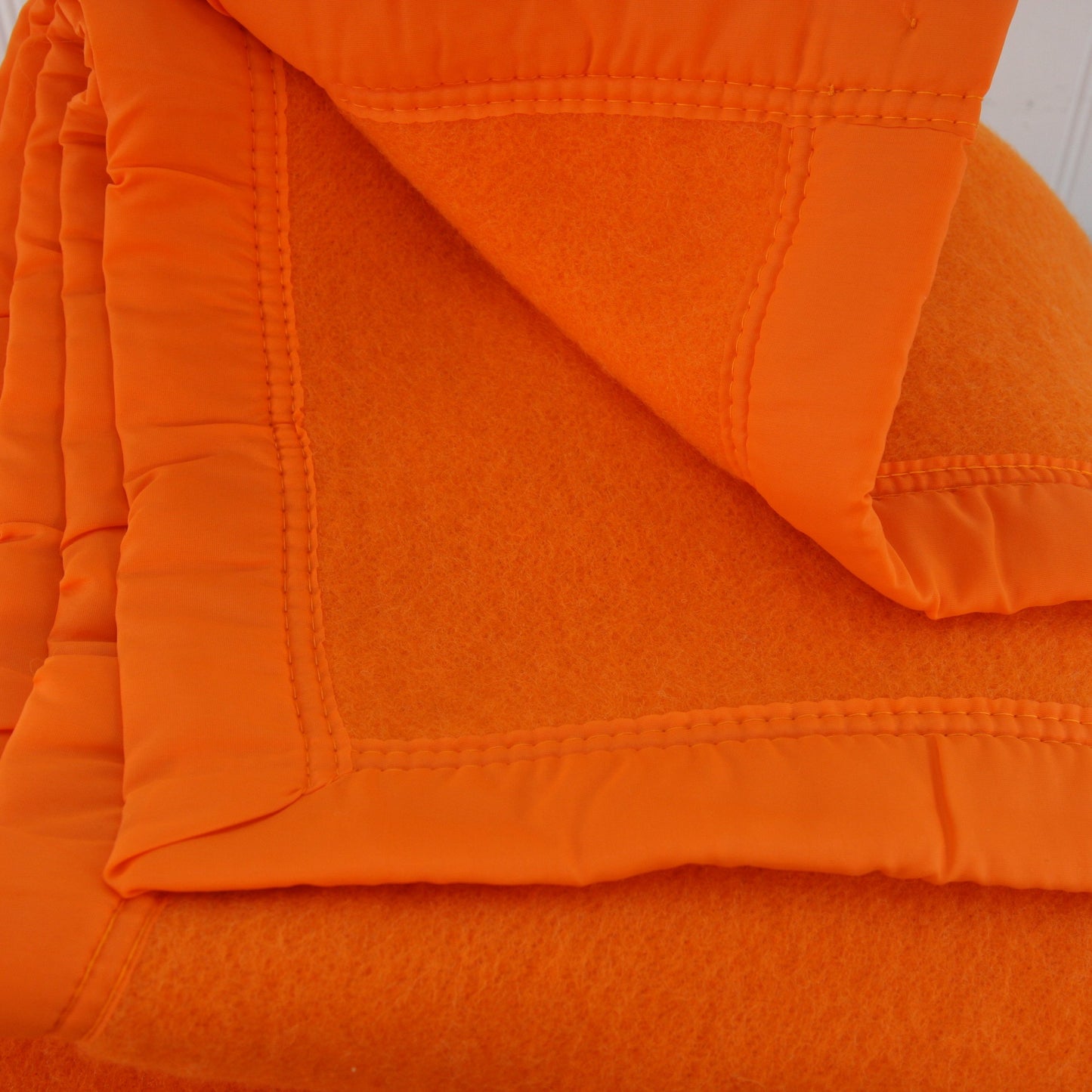 Folded Riviera Manta Acrylic Orange Blanket View of Corners