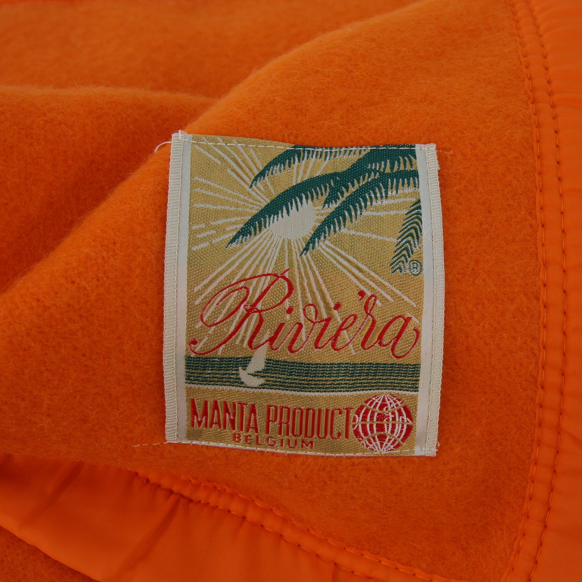 Folded Riviera Manta Acrylic Orange Blanket View of Manta Tag