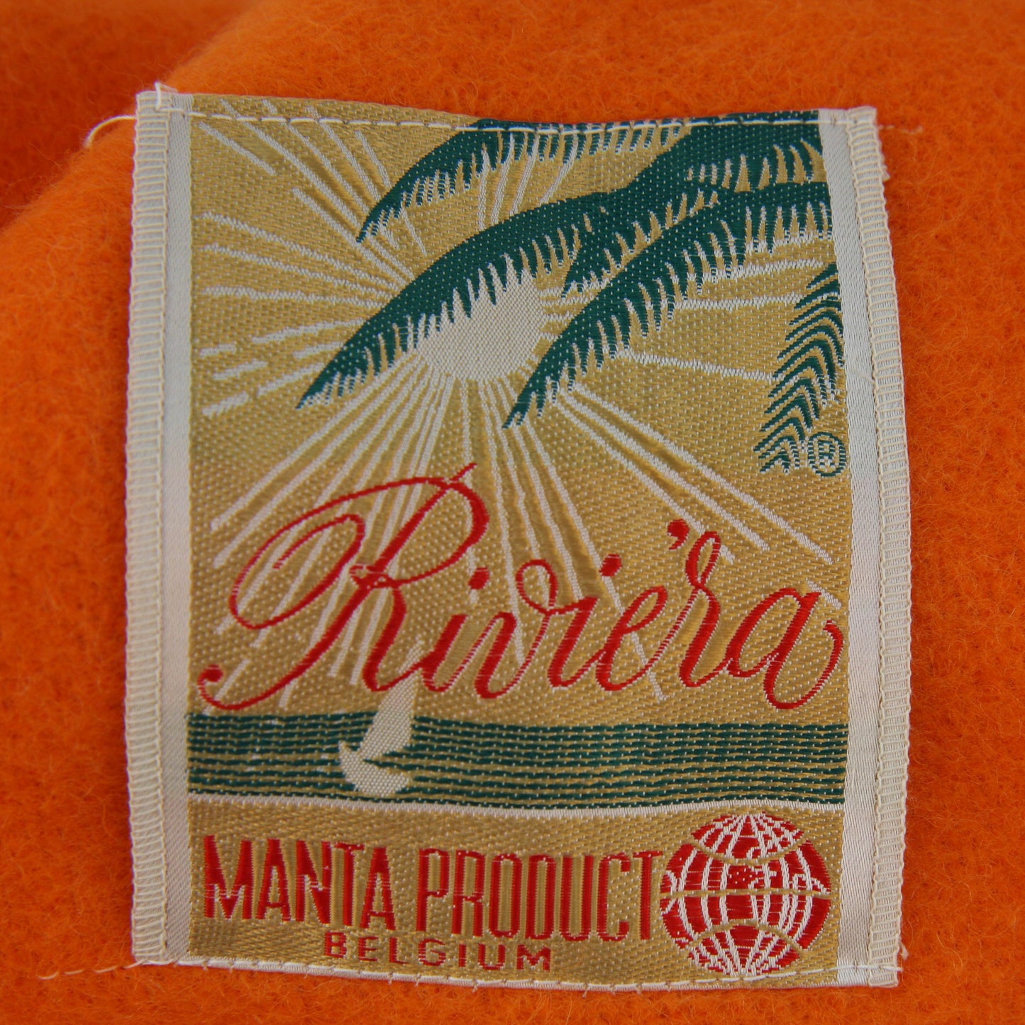 Folded Riviera Manta Acrylic Orange Blanket Tag Closeup