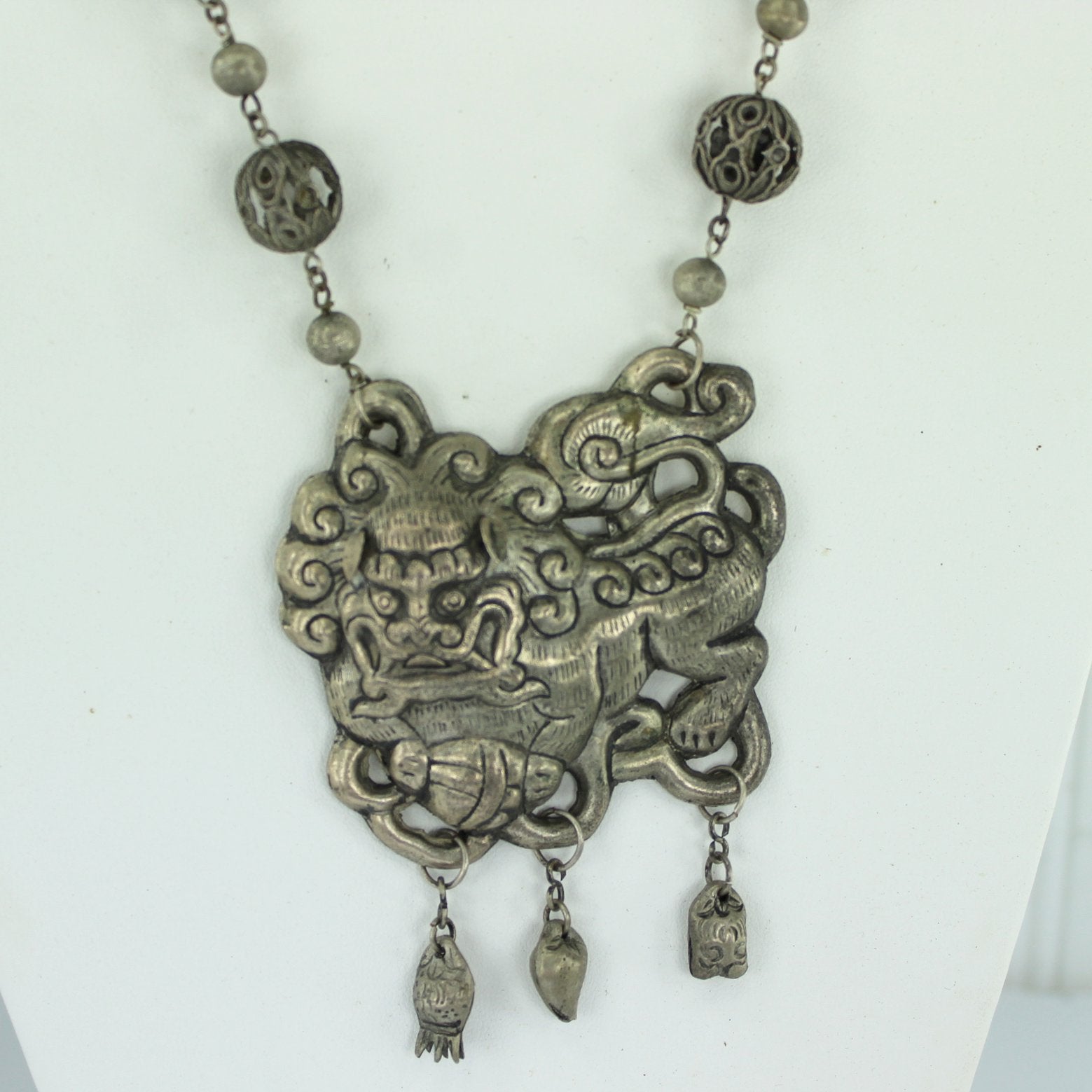 Silver Foo Dog Long Necklace Open Work Bead Intricate Chain Ethnic Origin closeup dog