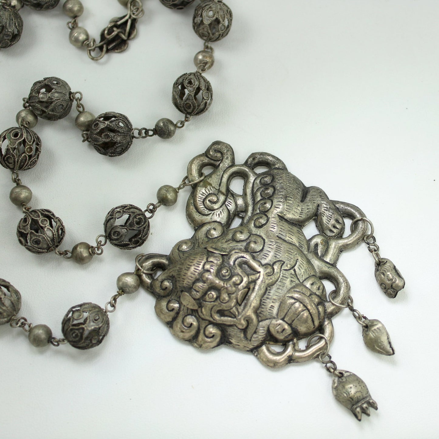 Silver Foo Dog Long Necklace Open Work Bead Intricate Chain Ethnic Origin closeup dog beads