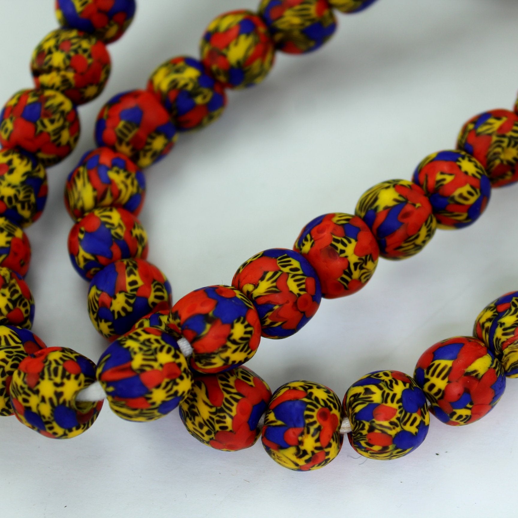 African Hand Made Necklace Colorful Beads Strand Wear DIY Red Yellow Blue closeup of beads
