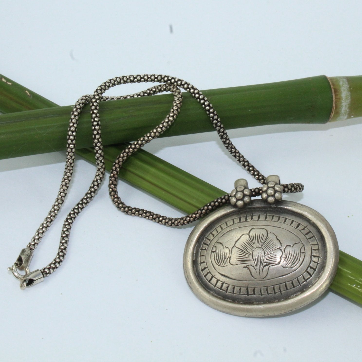 Tribal Necklace Silver Refined Etched Floral Double Bail Silver Decorative Chain closeup of medallion