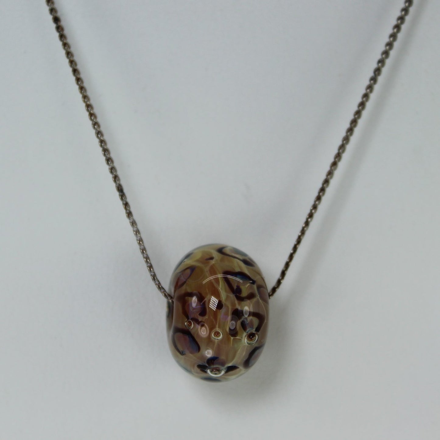 Leopard Pattern Glass Bead Necklace Silver Chain Mark NS closeup view bead