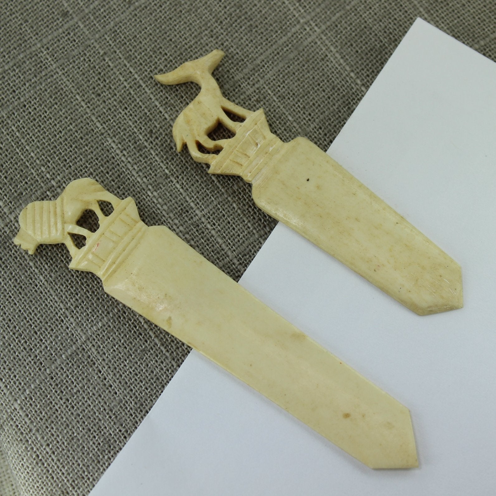 Pair Vintage Bone Bookmarks Letter Opener Lion Gazelle Carved showing paper inserted between 