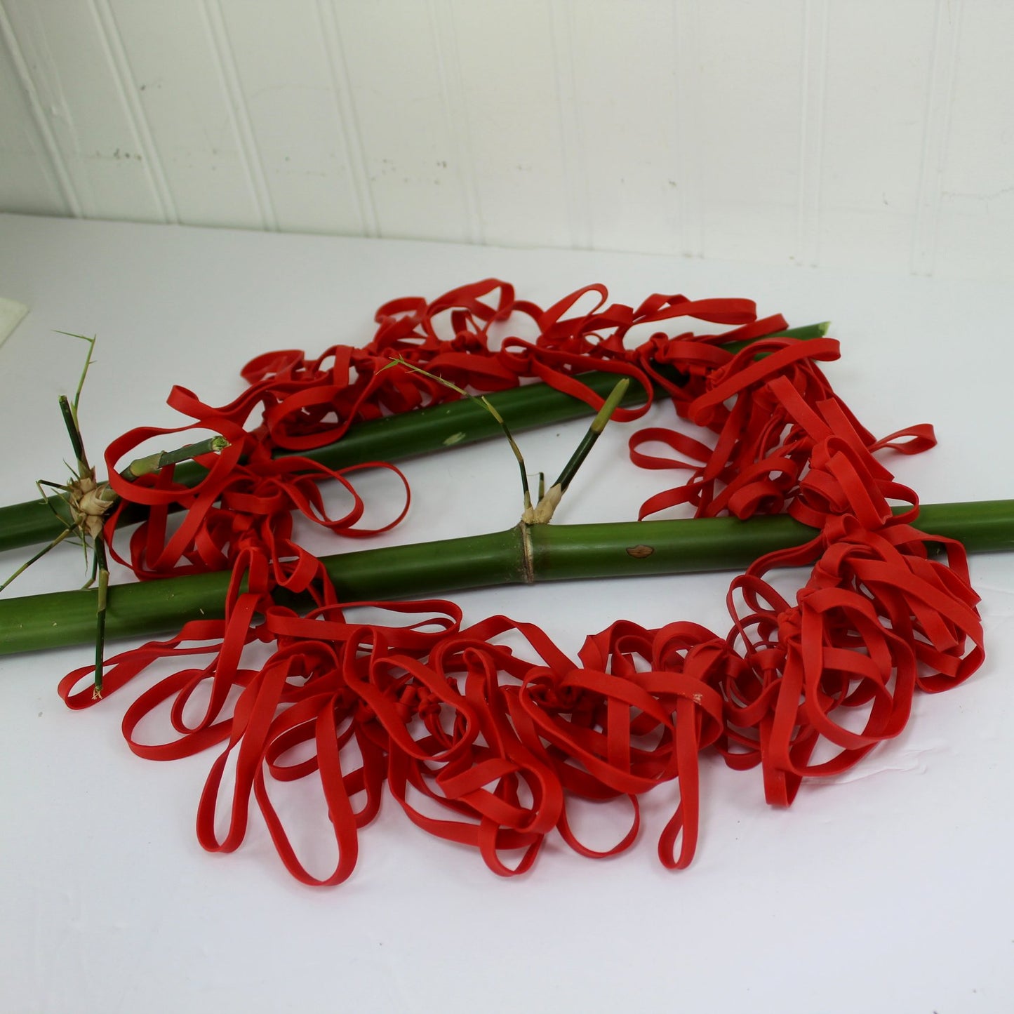 Red Lots of Rings Inner Tube Art Necklace Long Light Comfortable Fun Early 2000s on table view