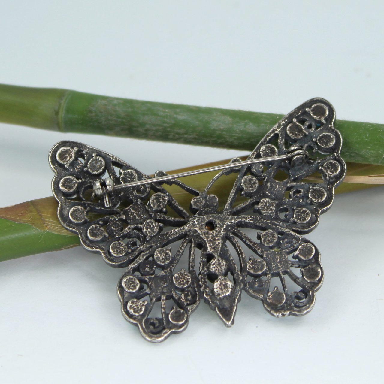 Brilliant Crystal Butterfly Pin Pewter Finish Blues Green Bright Pink Sparkling reverse of pin