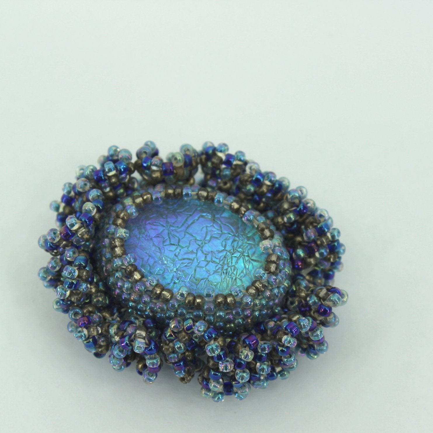 Pat Falk Early Work Glass Pin Iridescent Bead Ruffle Surround Brilliant Blues shades of brilliant blue