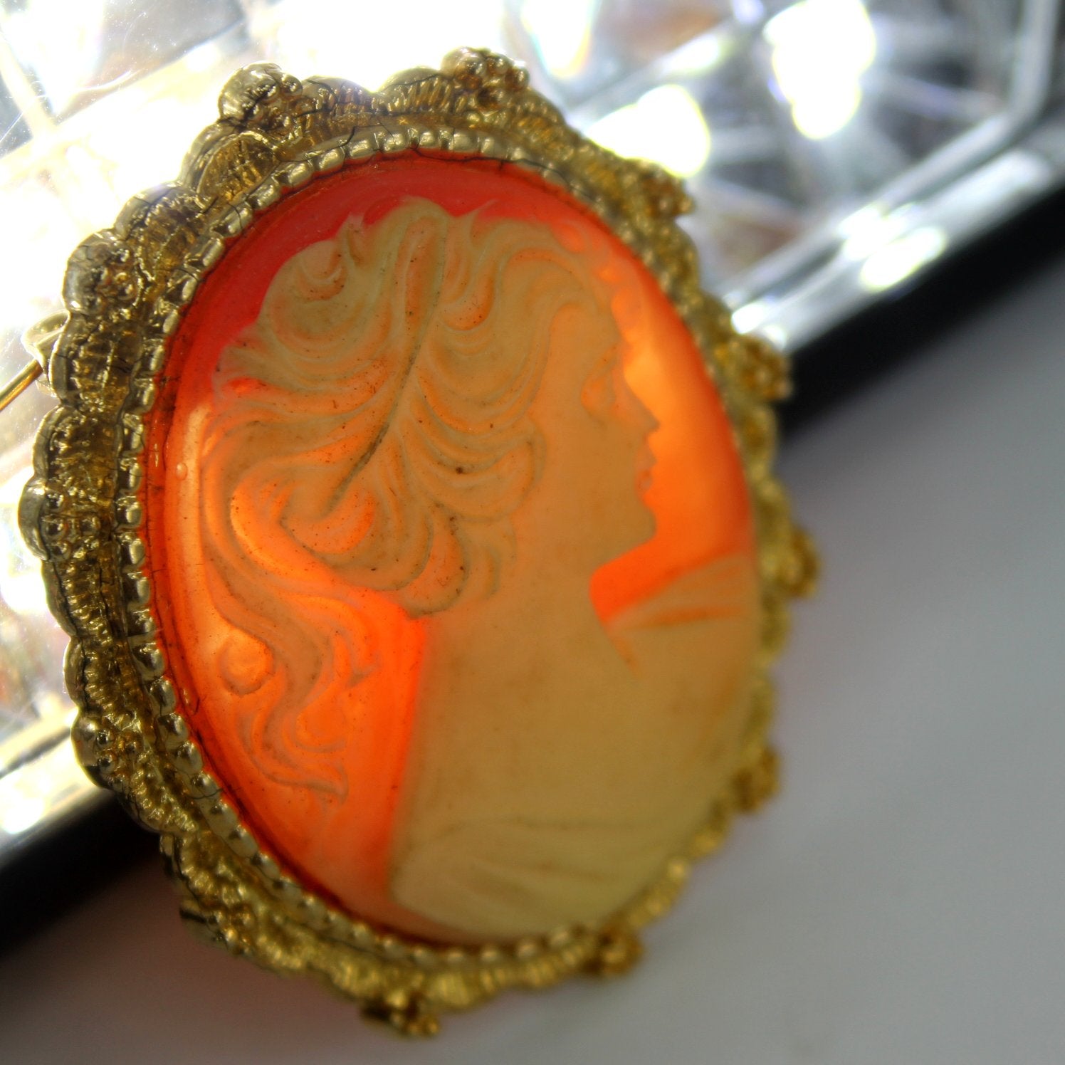 AAI Accessories Associates Inc Cameo Pin Brooch 1980s light behine photo showing quality resin