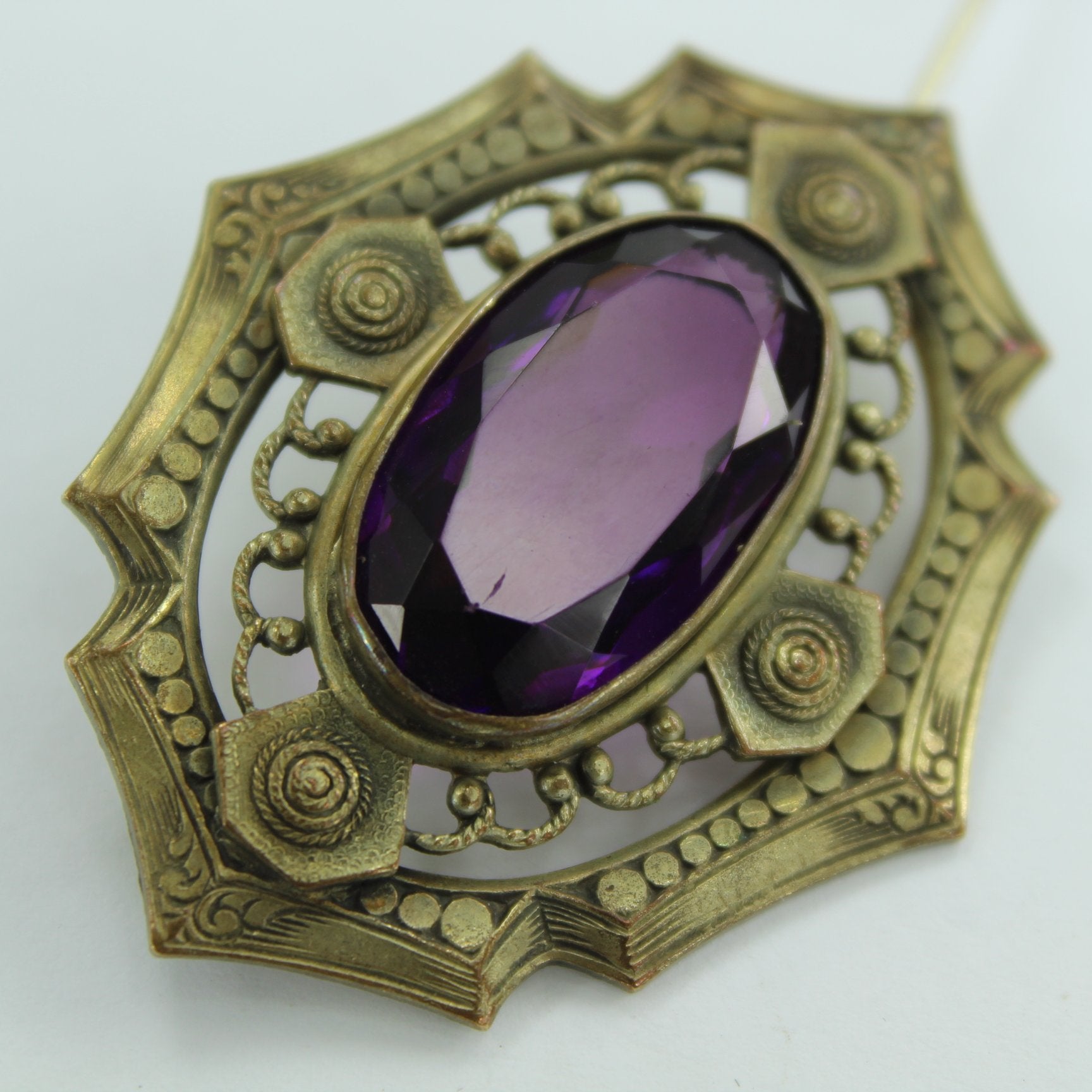 Old Faceted Amethyst Pin Intricate Surround C Closure closeup showing flaw scratch on amethyst