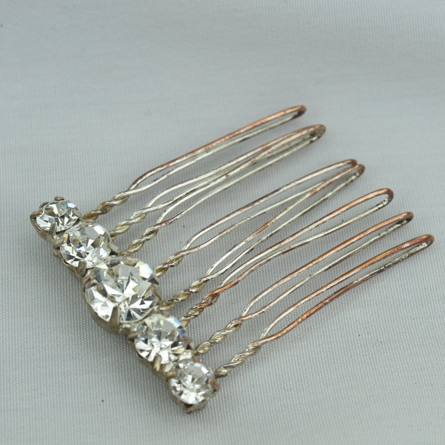 Neat Vintage Antique Hair Pin Decoration. Metal hair pin like base with large shiny Rhinestones. Metal shows vintage Stones great!  Fun piece. 
