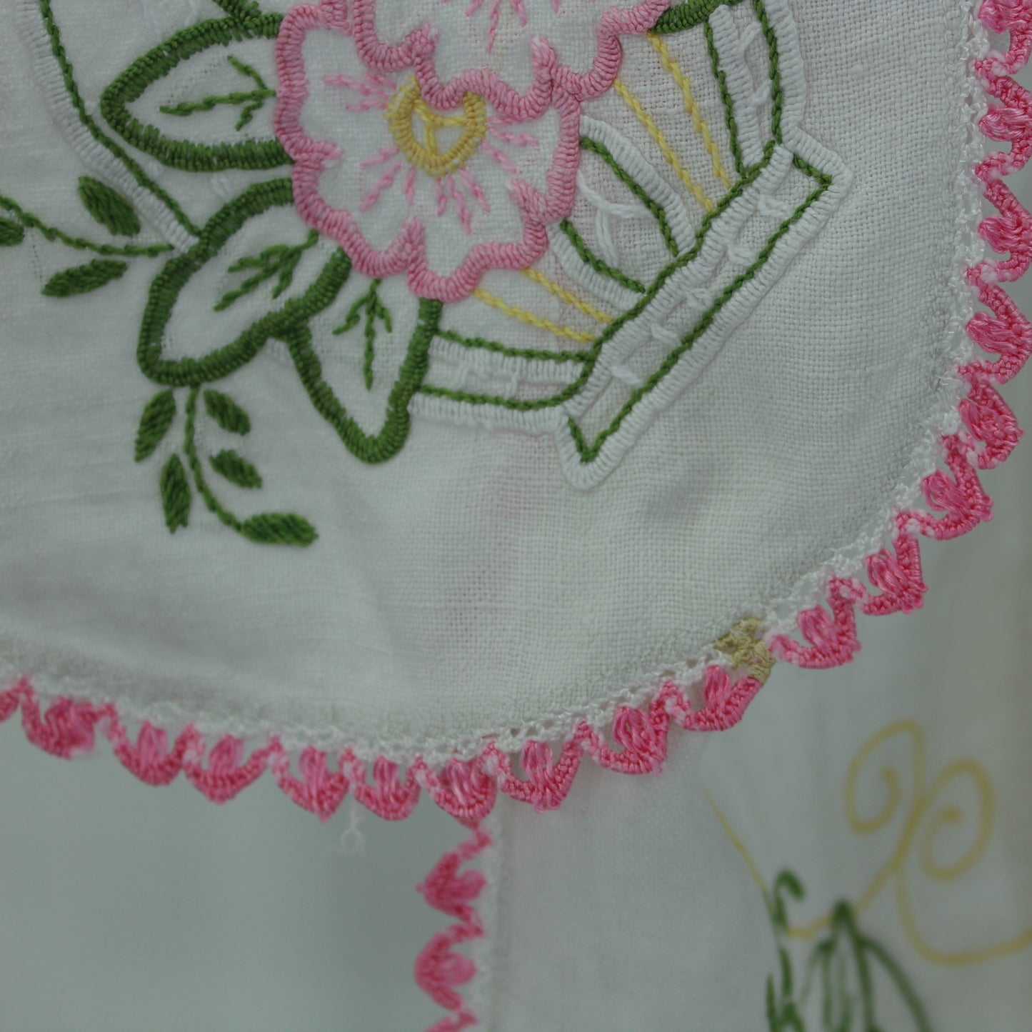 White Linen Table Center Runner Embroidered Flower Baskets Pink Green Crochet Edging closeup of small stain