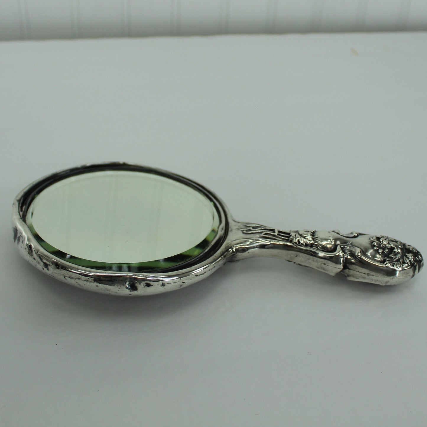 Antique Sterling Silver Hand Mirror Victorian Vanity Floral Art Nouveau Repousse lenthwise view of mirror and handle design