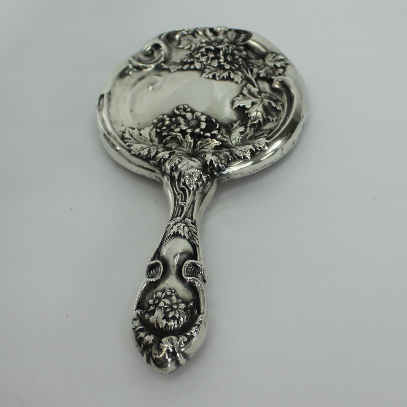 Antique Sterling Silver Hand Mirror Victorian Vanity Floral Art Nouveau Repousse view from handle of dimensional pattern