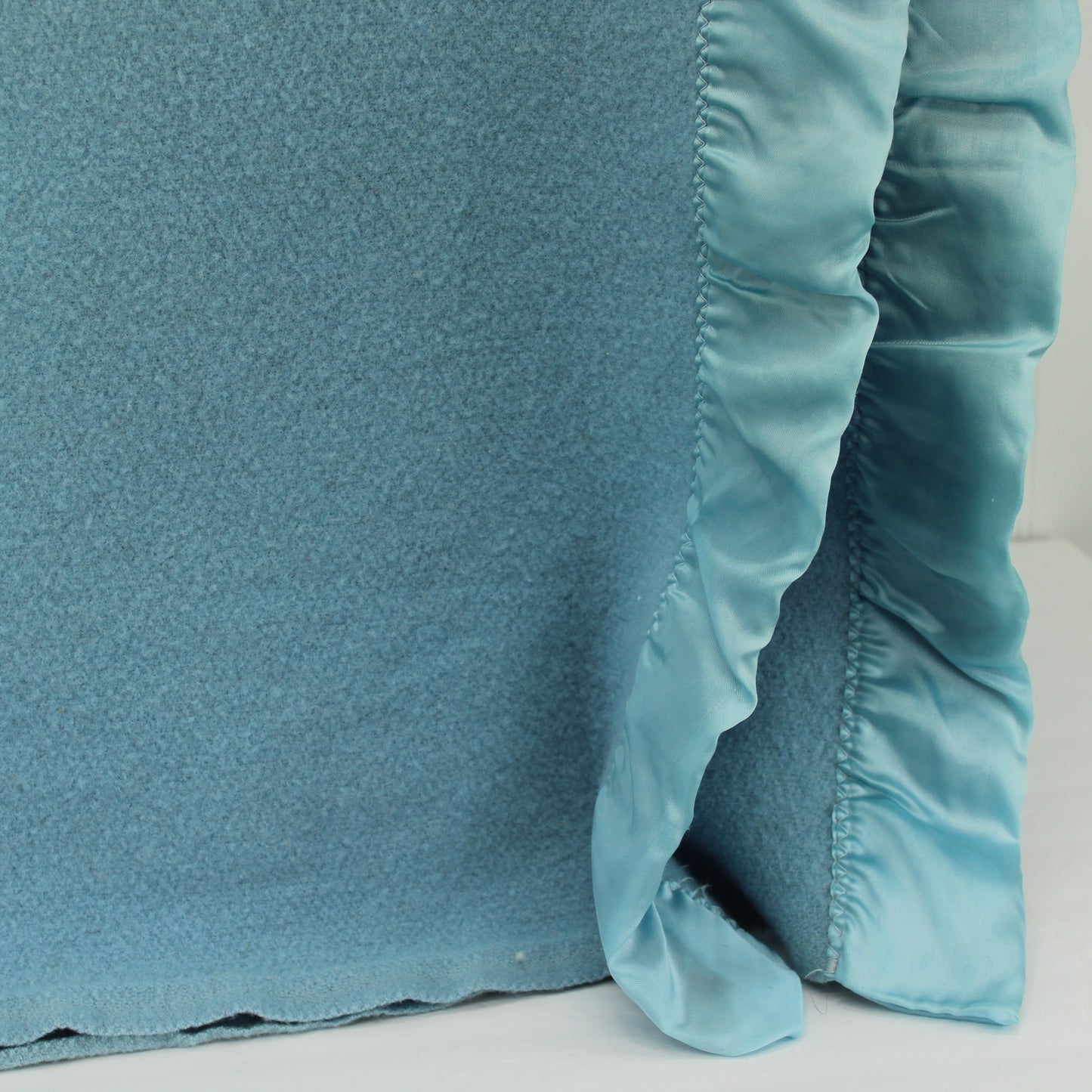 Copy of Faribo Wool Sky Blue Blanket Satin Binding 80" X 82" closeup view of blanket corner